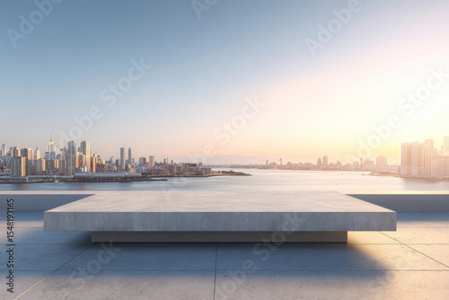 Concrete rooftop platform with panoramic city skyline and harbor view at golden hour
