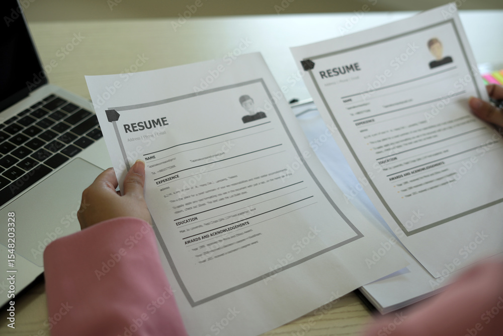 Obraz premium A young asian female Head of HR is reading resume and making a call for the recruitment interview process with the candidate who has been selected to work in the company, employment and HR concept.