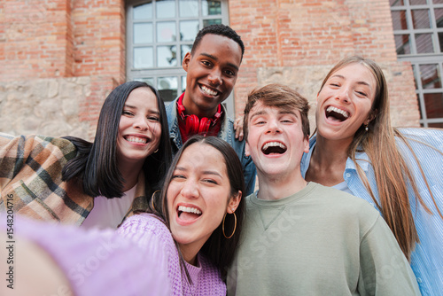 A cheerful group of friends enjoying their time together, taking a spontaneous selfie to cherish their joyful moments, laughter, and camaraderie, highlighting the essence of friendship and youth.