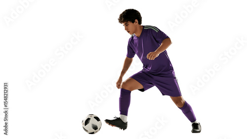 Soccer Player Dribbling: Young soccer player in purple uniform skillfully dribbling the ball, demonstrating agility and focus.