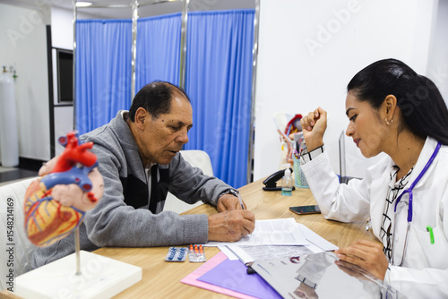 Elderly patient care by young female doctor in hospital