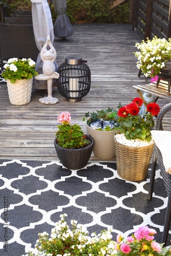 Lots of flowers in pots on a cozy terrace. A place to rest and relax.