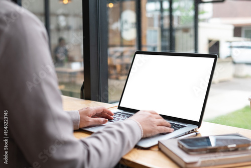 Young woman working on laptop with white screen