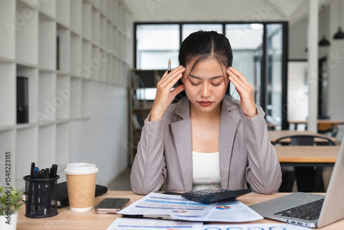 Businesswoman stressed from working hard in the office