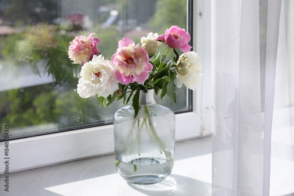 Bouquet of beautiful peonies in vase on window sill indoors Bouquet of beautiful peonies in vase on window sill indoors