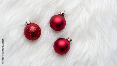 red Christmas balls on white fur