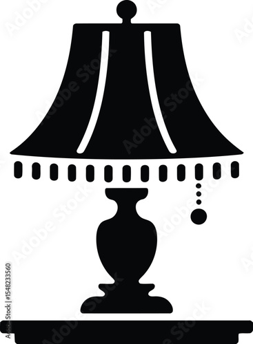 A black and white silhouette of a table lamp with a shade and a decorative hanging bead detail design
