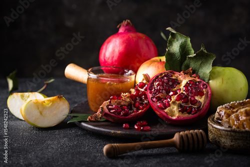 Rosh Hashana concept with honey, apple and pomegranate
