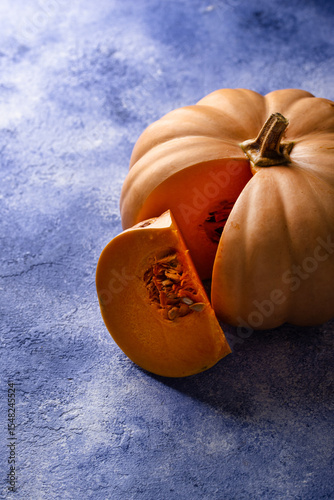 Raw fresh cut pumpkin on dark background