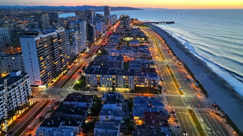 Aerial view of a beautiful cityscape at sunset with the ocean in background