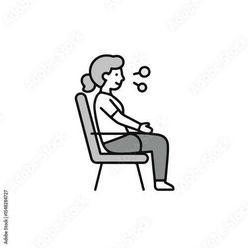 Woman sitting in a chair, thoughtfully.