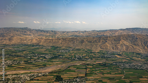 An Aerial View of Mountainous Terrain and Bustling Agricultural Fields in Vibrant Colors