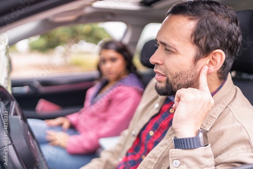 Konstfotografi Couple having car trouble listening to strange engine noise