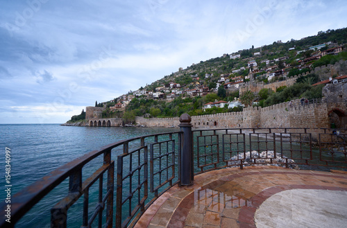 Scenic Coastal Town with Old Stone Walls and Calm Blue Sea
