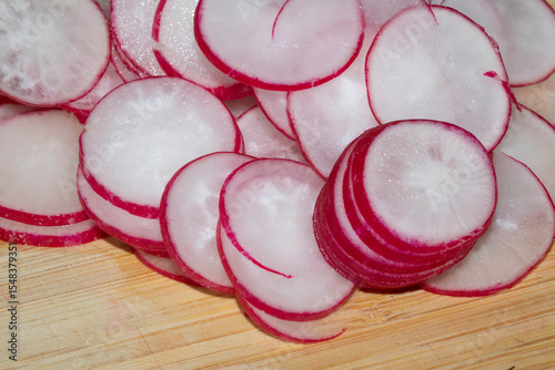 Chopped Up Sliced Radish on a Chopping Board in a Kitchen