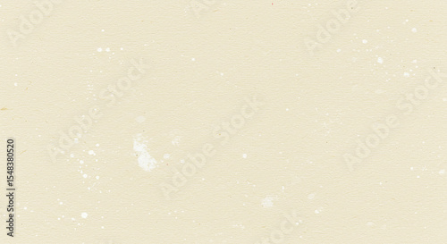 A light beige background with small white spots and some larger areas of white discoloration present on it