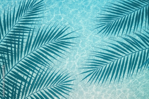 Tropical palm leaf shadows creating artistic patterns on crystal clear water surface at pristine beach