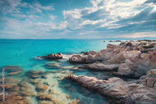Crystal Turquoise Blue Sea Water and Scenic Rocky Coastline Shore, Island Beach with Rocks Greece