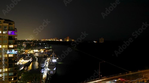 Time-lapse footage of yachts', airplanes and cars at night at the 17th Street Causeway Bridge.  Streaking lights and traffic make for interesting footage.