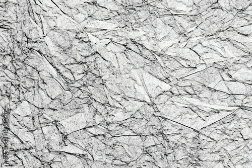 Black and white grunge texture with cracks and rough edges detailed close up of crumpled white paper with dark lines creating a textured appearance.