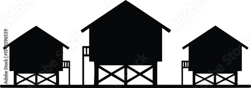 Stilt houses silhouette vector illustration of three elevated wooden homes in simple black design 