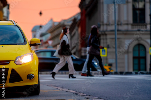Detail of yellow car against old city street