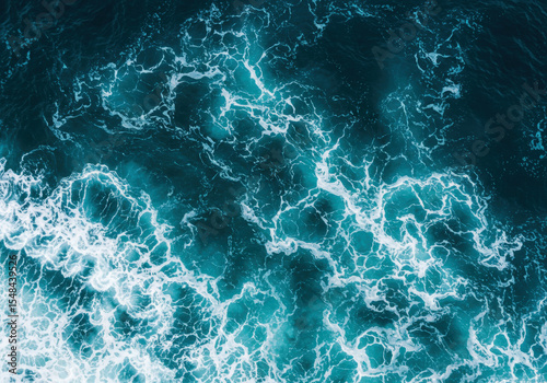 Fototapeta Naklejka Na Ścianę i Meble -  Abstract blue sea water with white foam for background