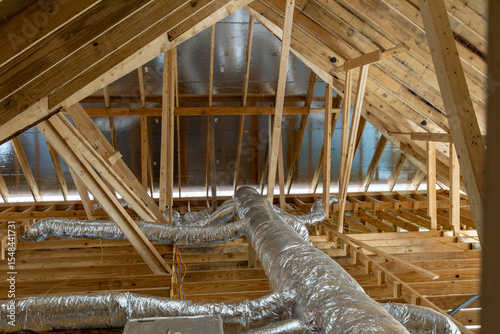New home construction attic exposed rafters hvac duct work trusses 