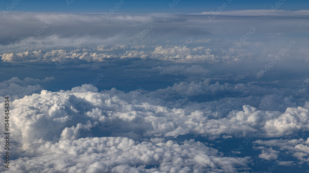 Fototapeta premium Experience the Captivating Aerial View of Beautiful Clouds and the Clear Blue Sky Above You