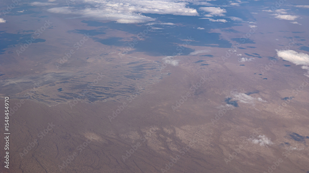Fototapeta premium A breathtaking and wide Aerial View of an Expansive Landscape Filled with Beautiful Clouds Above