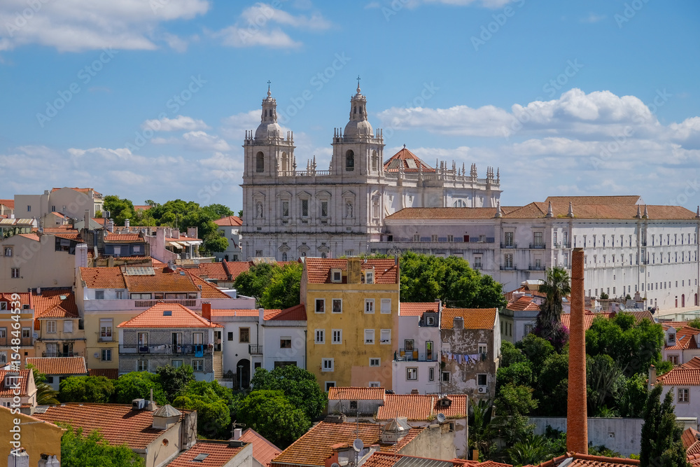 Fototapeta premium Monastery of São Vicente de Fora towers over old neighborhoods in Lisbon, Portugal