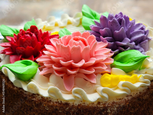 Bright aster flowers decorate a beautiful birthday cake