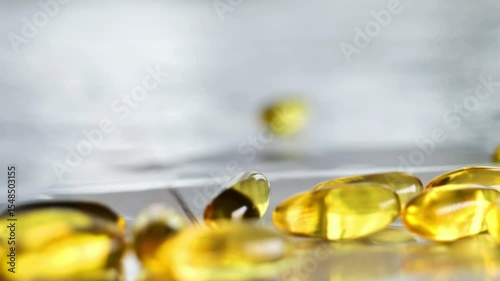 Omega fatty acids .Gelatin capsules fall on the table. Healthy fats and oils in nutrition. 4k footage