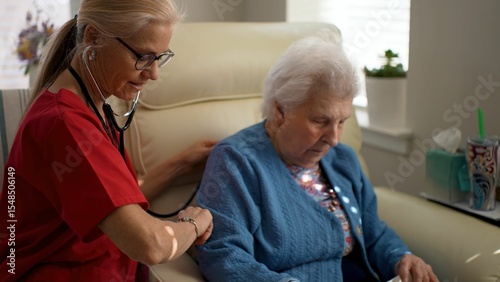 A caregiver attentively listens to the heartbeat of an elderly woman in a cozy setting, showcasing compassion and dedication to healthcare. photo