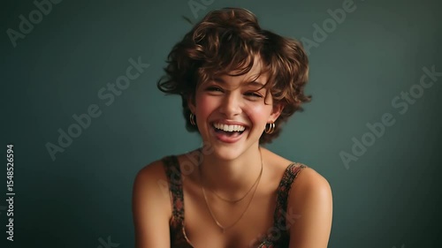 Energetic young woman smiling in studio background