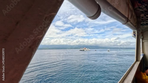 View of the sea through a ferry window during a sunny day crossing in the Philippines