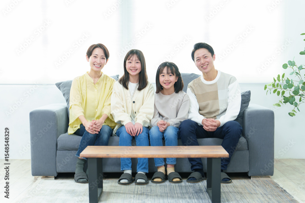 Fototapeta premium リビングのソファでリラックスする家族