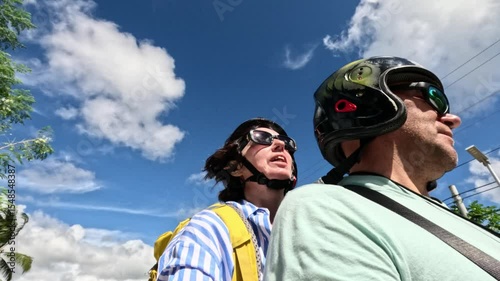 Travelers riding motorbike through scenic road under blue sky Motorbike travelers enjoying scenic ride under vibrant blue sky