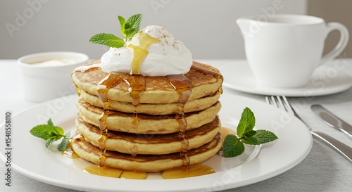 Indulge in a Stack of Fluffy Pancakes Topped with Whipped Cream, Honey, and a Hint of Mint for a Delightful Breakfast Experience.