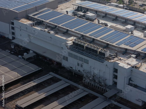 Cooling towers in data center building. Air conditioning cooling towers in front of building with fins to the front. Industrial cooling towers or air cooled water chillers with piping system.