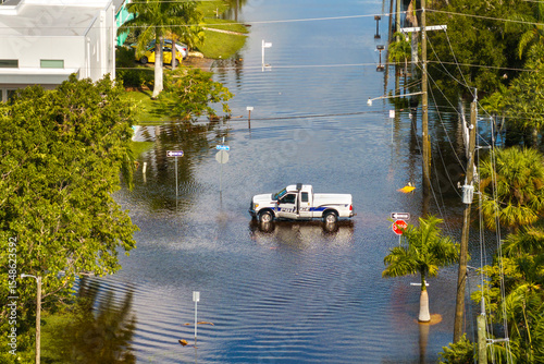 Road closed because of flooding danger with patrol police blocking driving of cars. Hurricane Milton aftermath in Punta Gorda, Florida photo