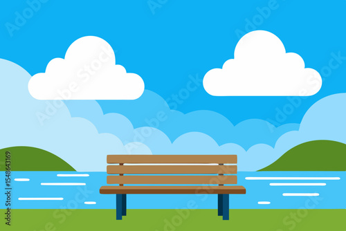 Wooden bench on a grassy hill in a park with blue sky and summer clouds