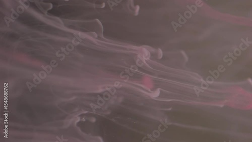 Vertical video. Blur fluid smoke. Liquid ink paint. Defocused pink colorful shine drops flow vapor cloud texture waves on abstract art background.