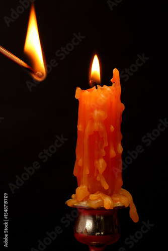  lit candle on  black