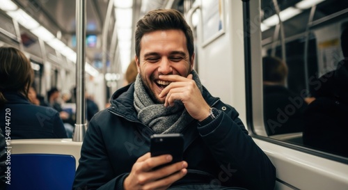 Wallpaper Mural Young man laughing while using smartphone on subway train during commute Torontodigital.ca