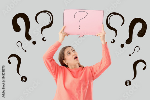 Puzzled woman holding paper...