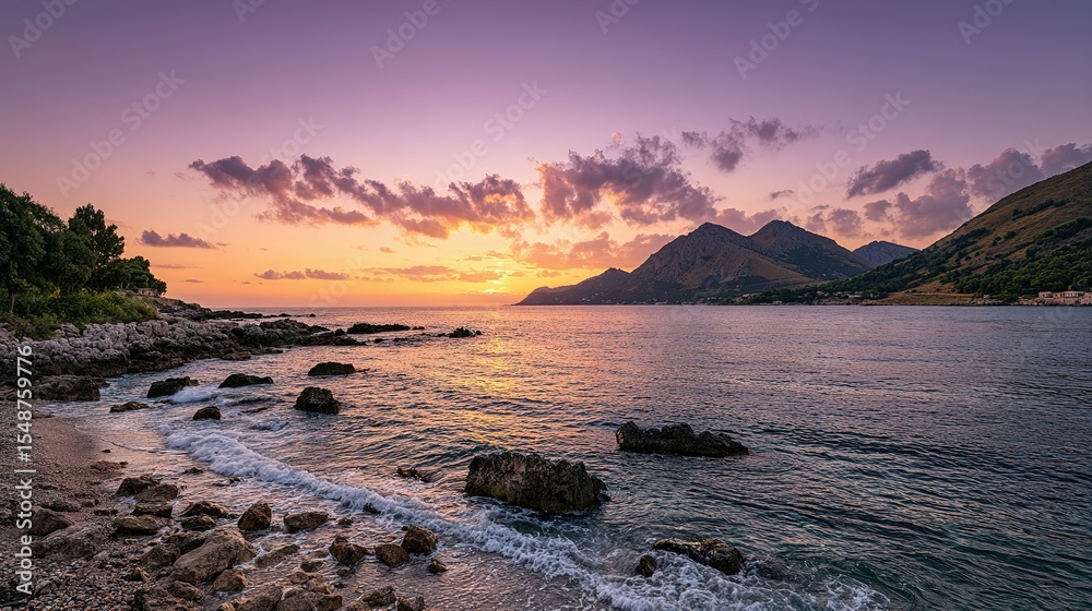 Naklejka premium Tranquil sunset over a rocky coastline.