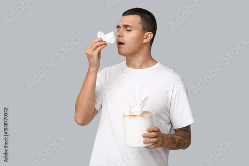 Ill young man with tissues ...