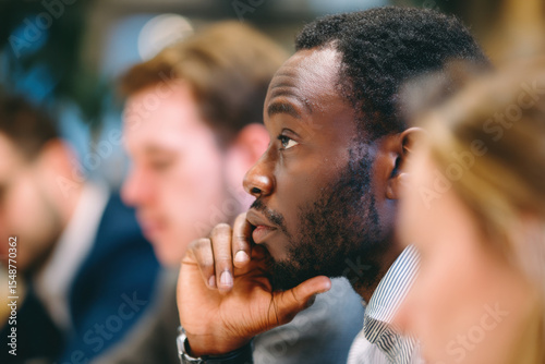 Engaged listener during meeting, showcasing focus and contemplation in professional setting