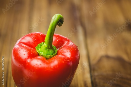Fresh red pepper on wooden table